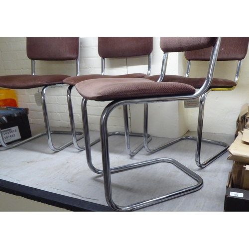 302 - A set of four modern tubular stainless steel framed and cantilevered office chairs with patterned re... 