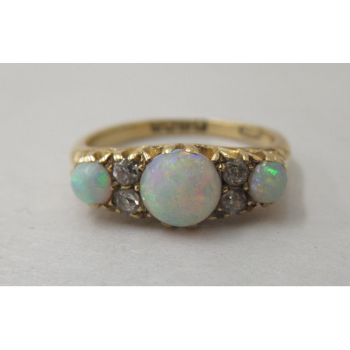 304 - An 18ct gold opal and diamond ring