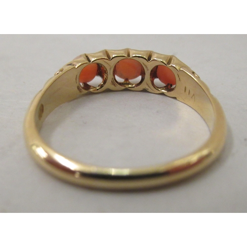 305 - A yellow metal ring, set with diamonds and coral