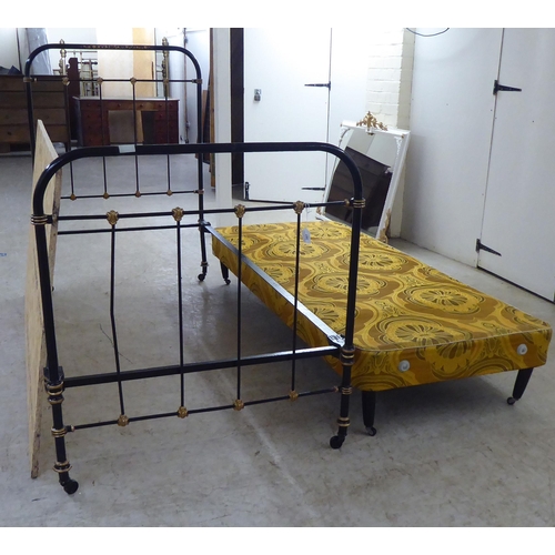 307 - A Victorian later black painted and gilded iron bedhead and foot of tubular and railed construction,... 