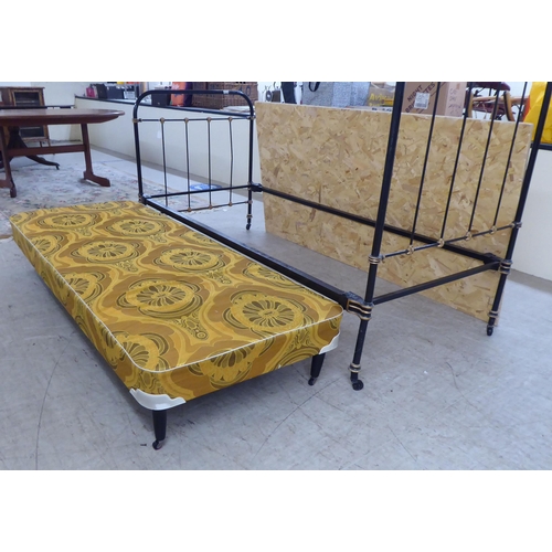 307 - A Victorian later black painted and gilded iron bedhead and foot of tubular and railed construction,... 