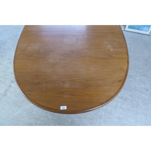 308 - A modern teak extending dining table, the oval top incorporating an integrated additional leaf, rais... 