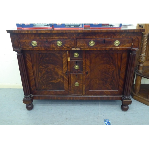 31 - A William IV mahogany sideboard with a pair of inline drawers and three short central box drawers, f... 