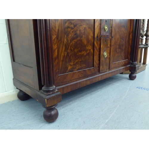 31 - A William IV mahogany sideboard with a pair of inline drawers and three short central box drawers, f... 