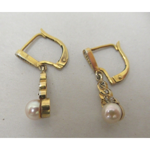 310 - A pair of yellow metal pearl drop earrings