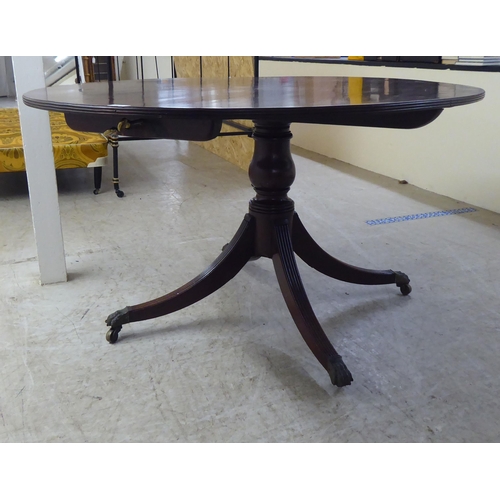 311 - A 20thC Regency style mahogany oval, tip-top breakfast table with a reeded edge, over a vase turned ... 