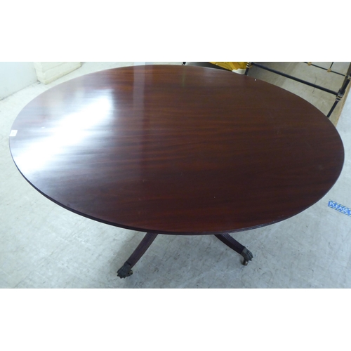 311 - A 20thC Regency style mahogany oval, tip-top breakfast table with a reeded edge, over a vase turned ... 