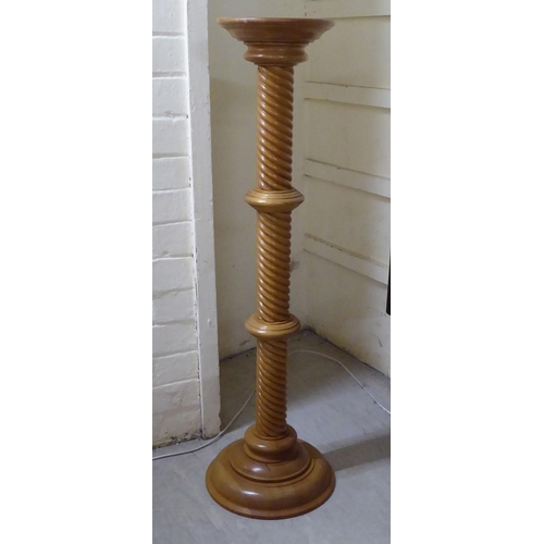 316 - A modern honey coloured light oak, spiral carved torchere, on a turned base  39