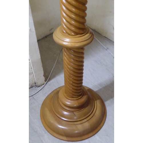 316 - A modern honey coloured light oak, spiral carved torchere, on a turned base  39