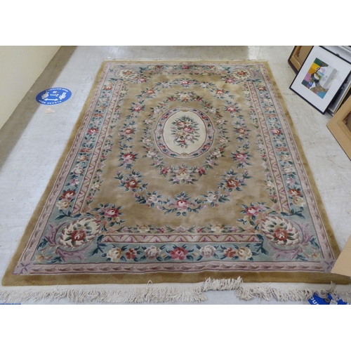 317 - A modern cotton carpet, decorated in pastel colours with floral designs  120