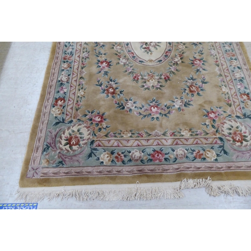 317 - A modern cotton carpet, decorated in pastel colours with floral designs  120