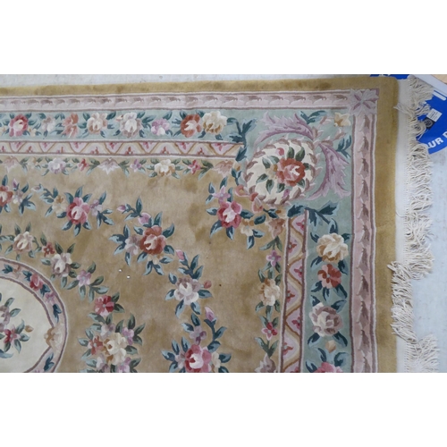 317 - A modern cotton carpet, decorated in pastel colours with floral designs  120