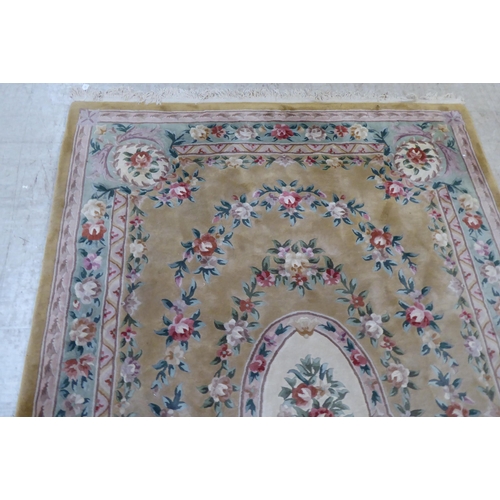 317 - A modern cotton carpet, decorated in pastel colours with floral designs  120