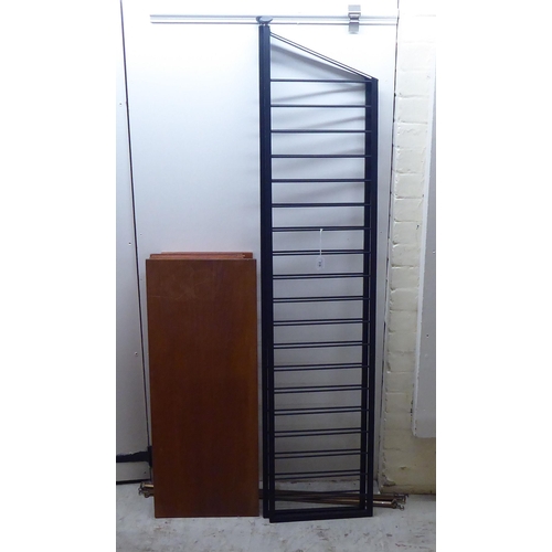 318 - A 1960/70s ladder design, black painted iron wall unit with five shelved tiers  66