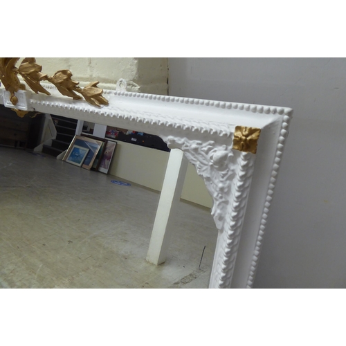 321 - A 19thC and later white painted and gilded overmantel mirror with gesso ornament  36