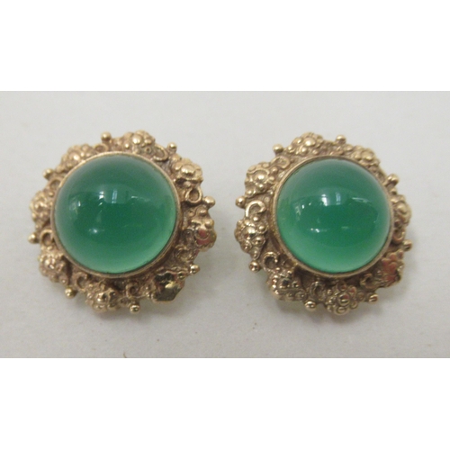 328 - A pair of 9ct gold clip earrings, each set with green stone