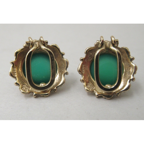 328 - A pair of 9ct gold clip earrings, each set with green stone