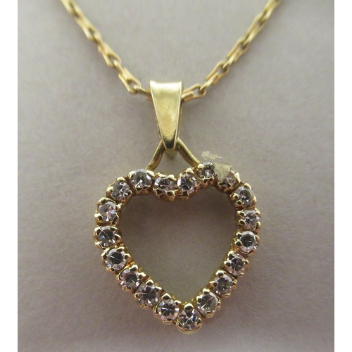 34 - An 18ct gold and diamond set heart shape pendant, on a fine neckchain and ring bolt clasp 