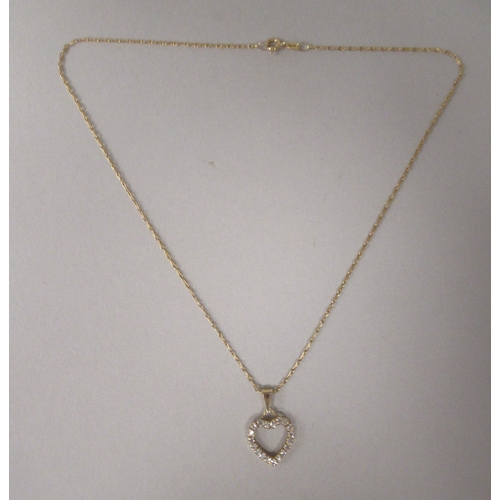 34 - An 18ct gold and diamond set heart shape pendant, on a fine neckchain and ring bolt clasp 