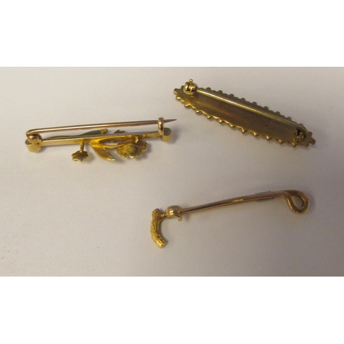 37 - Three late Victorian scarf pins, viz. a 15ct gold riding crop; and two yellow metal examples 