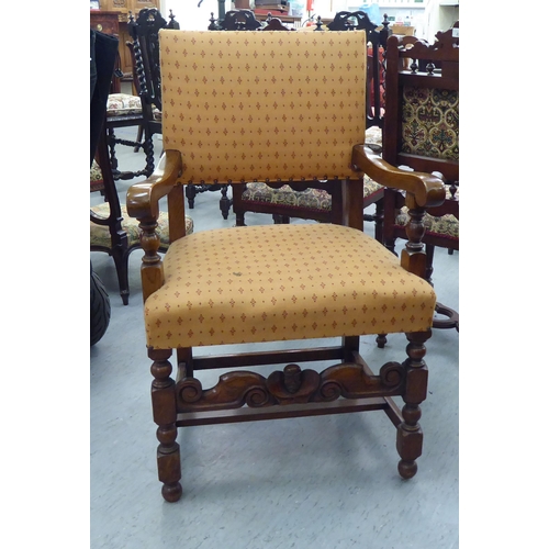 39 - A 20thC Cromwellian style oak framed dining chair with an upholstered back and seat, raised on turne... 