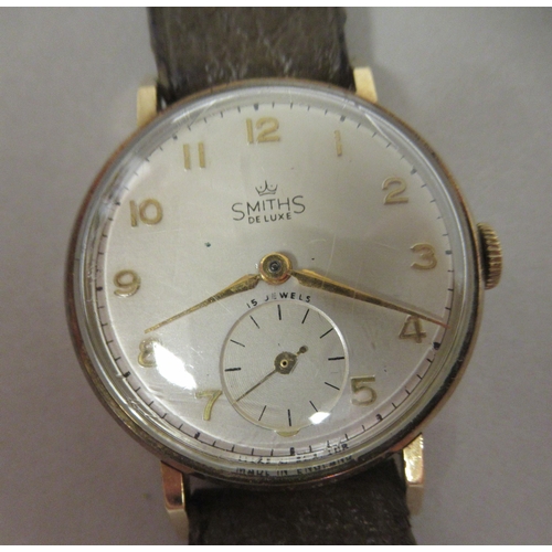 40 - A 1950s Smiths DeLuxe 9ct gold cased wristwatch, faced by a gilded Arabic dial, incorporating subsid... 