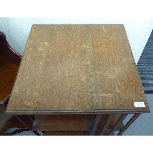 41 - An Edwardian oak revolving bookcase with slatted sides, on platform feet  43