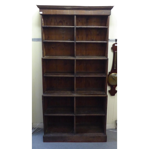 45 - A 20thC rustic oak three tier waterfall front bookcase, on a plinth  83