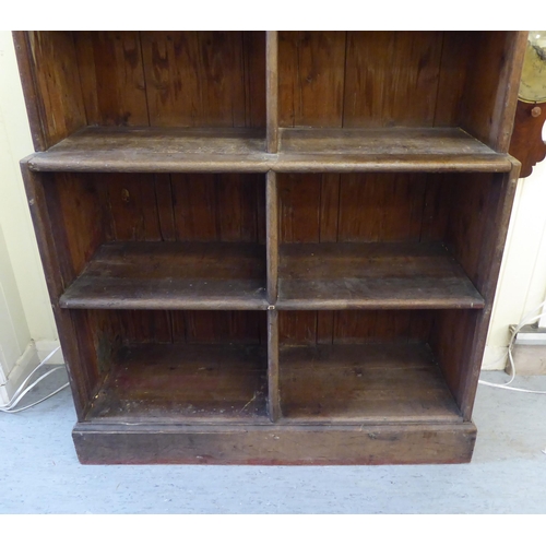 45 - A 20thC rustic oak three tier waterfall front bookcase, on a plinth  83