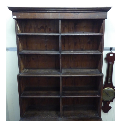 45 - A 20thC rustic oak three tier waterfall front bookcase, on a plinth  83