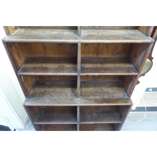 45 - A 20thC rustic oak three tier waterfall front bookcase, on a plinth  83