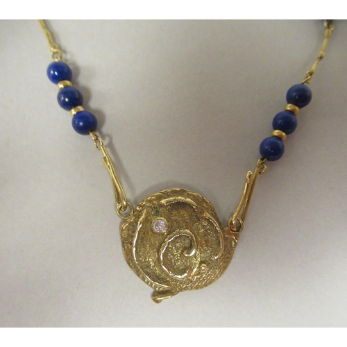 48 - An 18ct gold Scandinavian lapis lazuli and diamond set pendant, on a rod and ring link neckchain&nbs... 