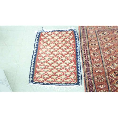 54 - Rugs: to include a Kilim examples with floral motifs, on a red and blue ground  37