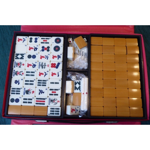 69 - A Mah-jong set with bamboo effect resin tiles, in a travel case