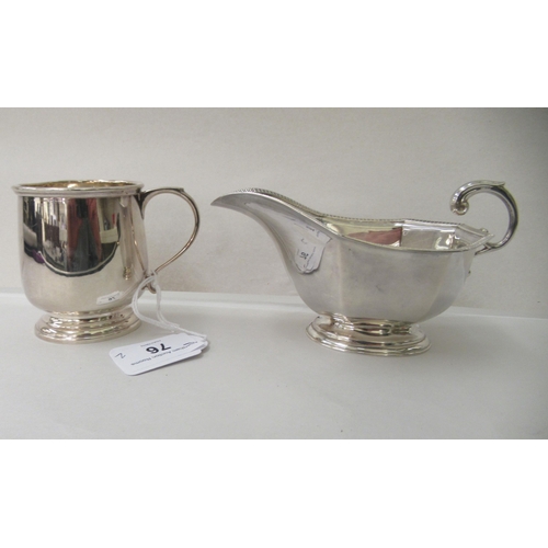 76 - A silver Christening mug with an applied wire rim and C-scroll handle, on a pedestal footrim; and a ... 