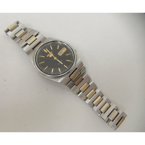 150 - A Seiko 5 automatic wristwatch, faced by a baton dial with day/date aperture