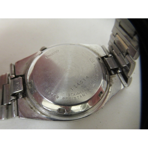 150 - A Seiko 5 automatic wristwatch, faced by a baton dial with day/date aperture