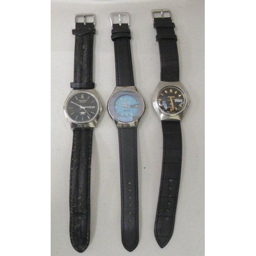 156 - Two Citizen and one Ricoh stainless steel cased automatic wristwatches, each faced by a baton dial, ... 