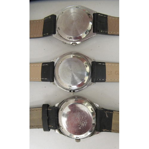 156 - Two Citizen and one Ricoh stainless steel cased automatic wristwatches, each faced by a baton dial, ... 