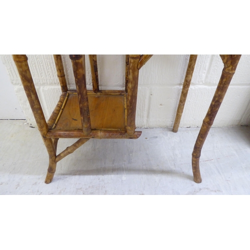 104 - A 20thC bamboo and pine panelled display stand with offset, graduated open shelves  54