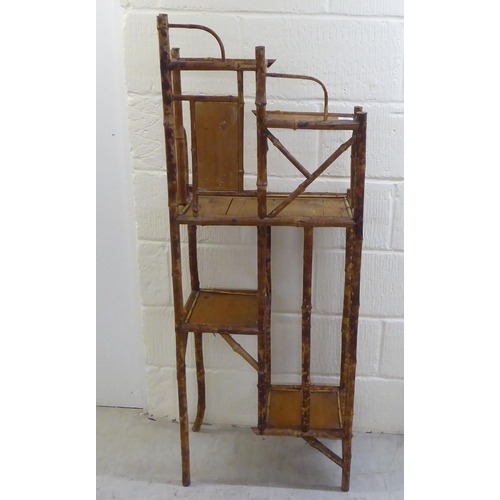 104 - A 20thC bamboo and pine panelled display stand with offset, graduated open shelves  54