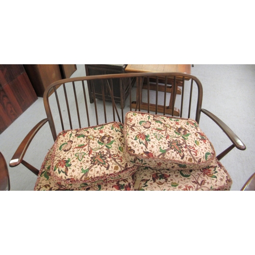 107 - An Ercol dark stained beech and elm framed, hoop and spindle back, three piece suite with floral pat... 