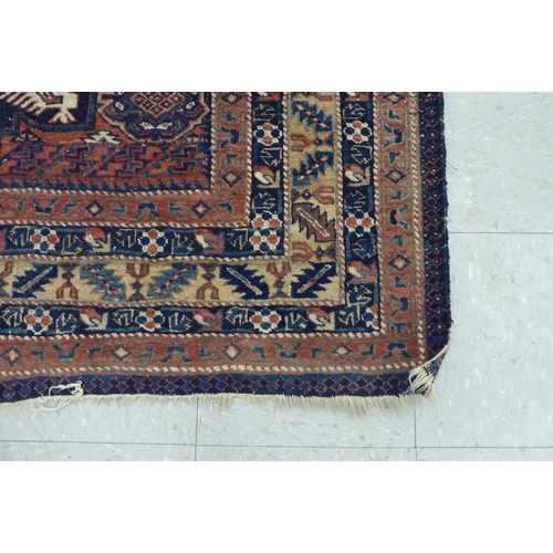 111 - A Caucasian rug, decorated with three central medallions, bordered by stylised designs, on a multi-c... 