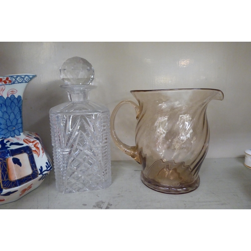 127 - Decorative ceramics and glassware: to include a clear and cranberry coloured vase  10.5