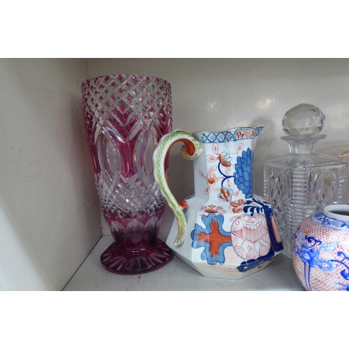 127 - Decorative ceramics and glassware: to include a clear and cranberry coloured vase  10.5