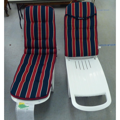 149 - A pair of Allibert Cormoran wheeled white plastic sun-loungers with De Luxe Blazer cushions