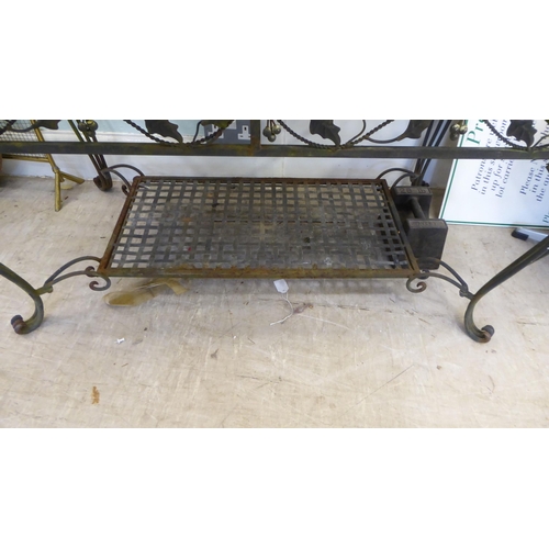 15 - A modern rust coloured metal terrace table with a basketweave design top, raised on wrought iron leg... 