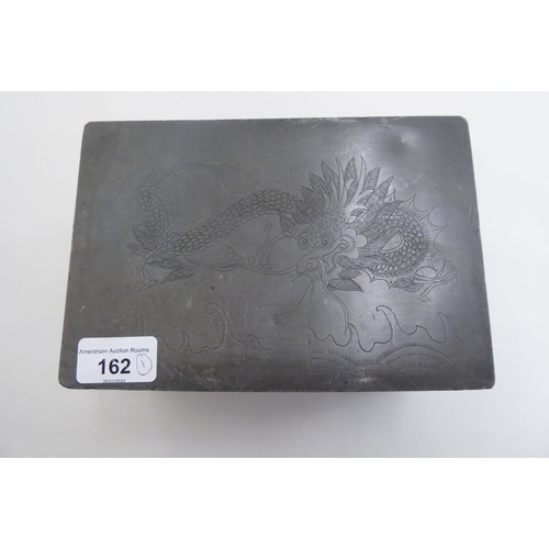 162 - A 20thC Chinese pewter lidded box, decorated with dragons and foliage  4