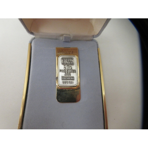 189 - A yellow metal money clip, set with a 2grm ingot of .999 silver