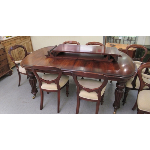 197 - A Victorian style mahogany wind-out dining table, the top comprising a pair of D-ends and two additi... 